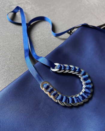 industrial ring necklace with steel rings on blue a cord