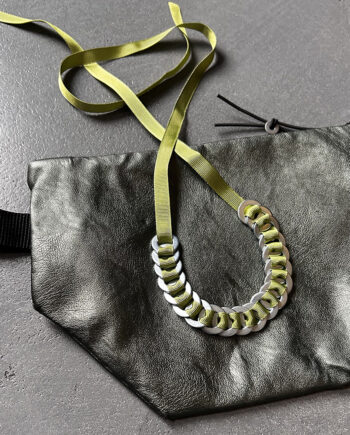 industrial ring necklace with steel rings on a green cord